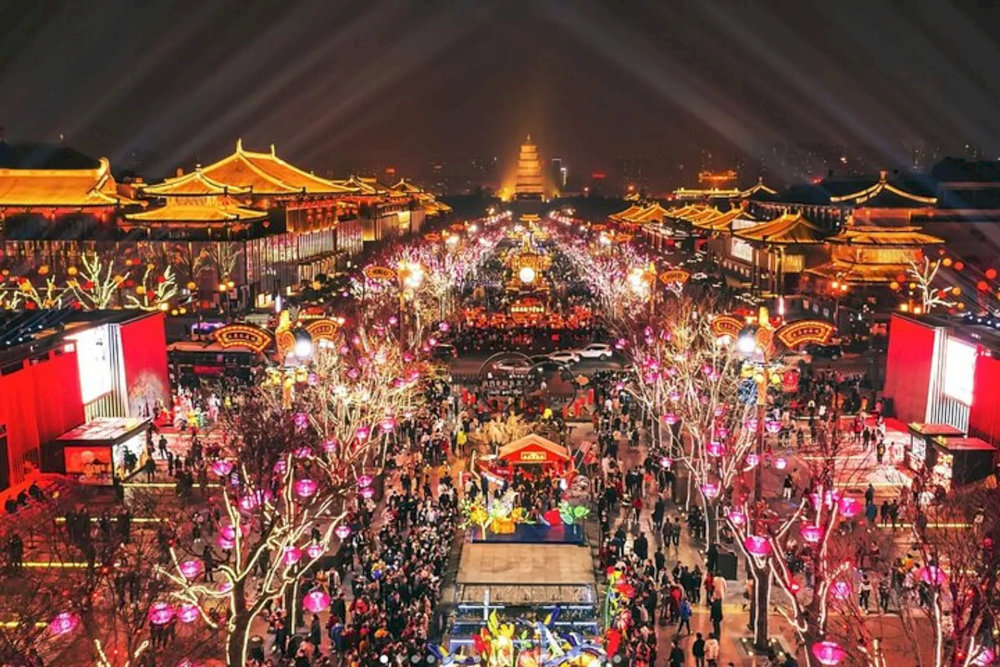 The vibrant night life at Grand Tang Mall with many activities like shopping, walking and watching traditional performances